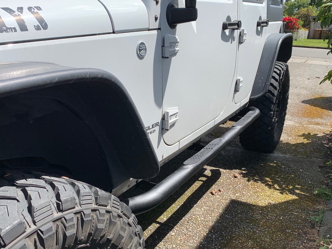 Jeep Licensed by RedRock 3-Inch Round Curved Side Step Bars with Jeep Logo; Textured Black (07-18 Jeep Wrangler JK 4-Door)